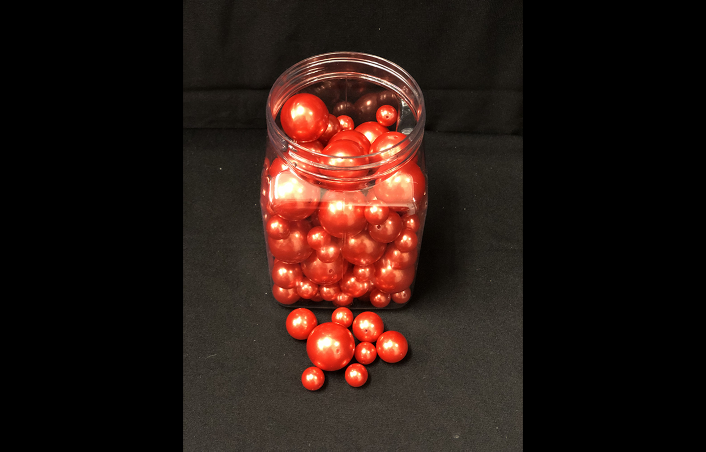 Jar of orange pearl beads