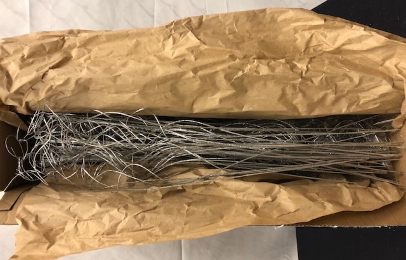 Fake silver branches inside a cardboard box