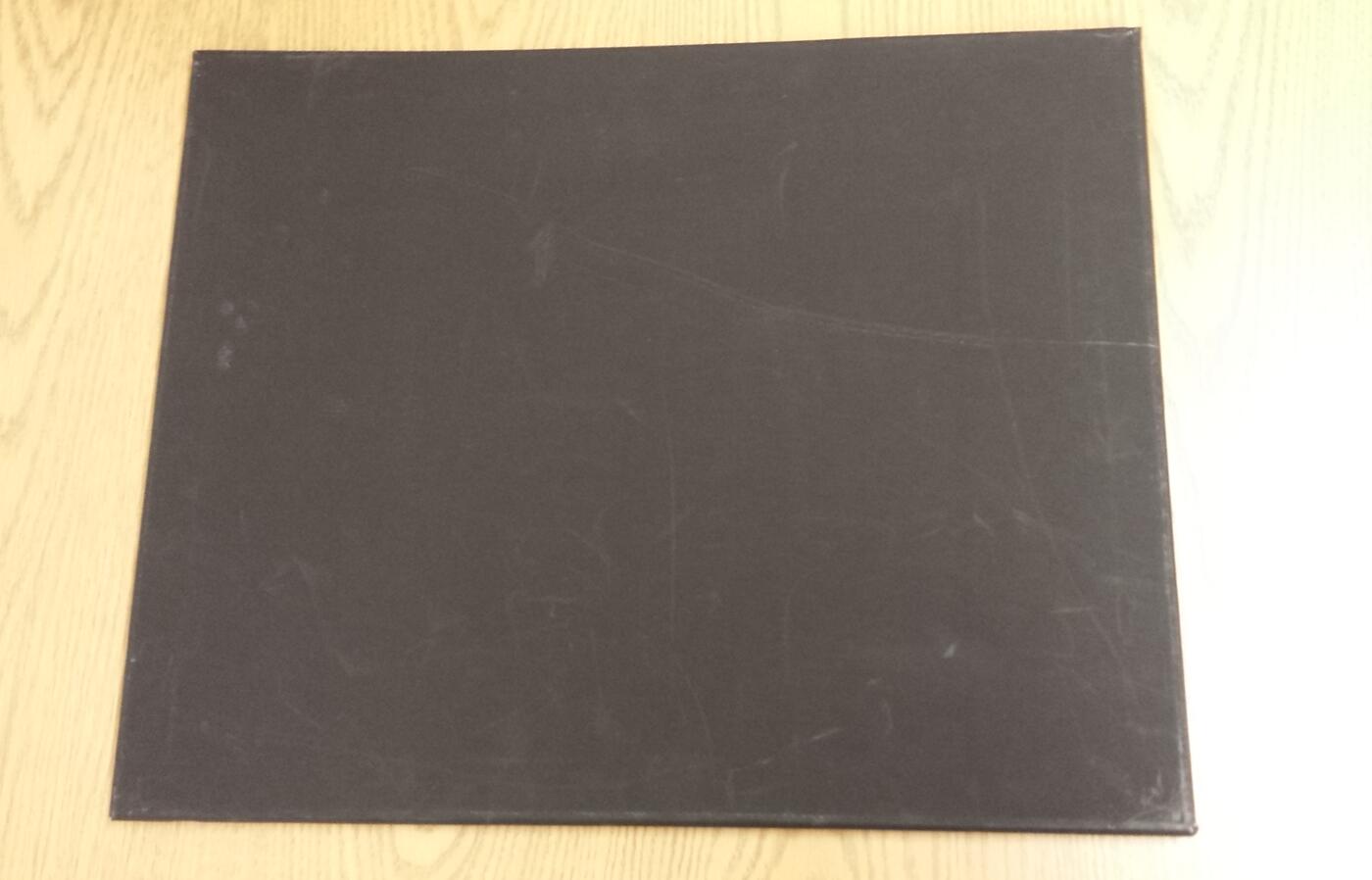 Black board on a wooded background