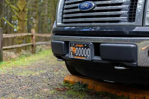 front grill of large truck with new OSU Beaver license plate